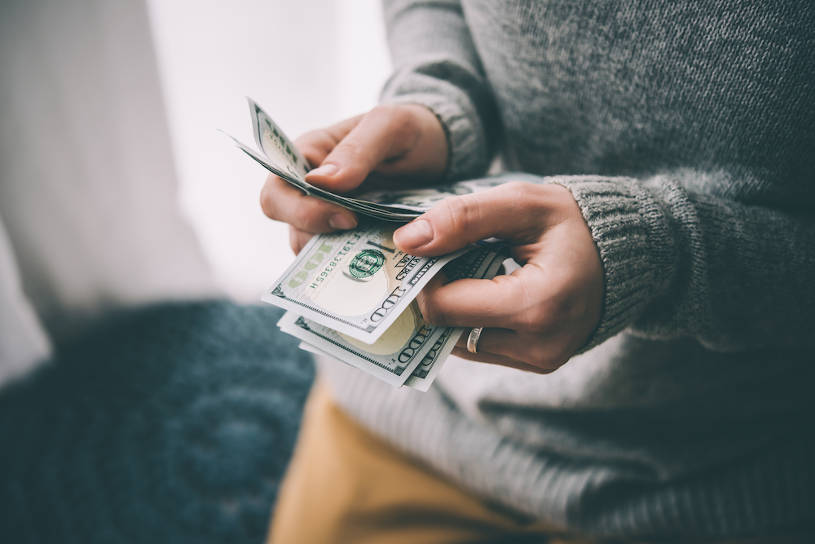 Woman counting money for rehab.