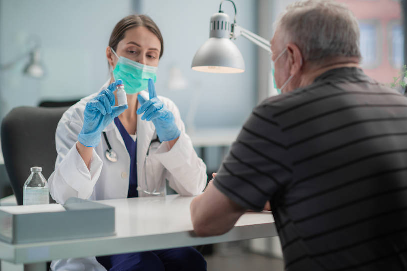 doctor explains drug withdrawal to an elderly man.