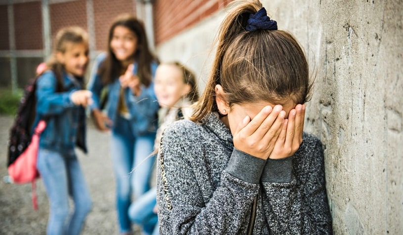 Sad girl intimidated at school.