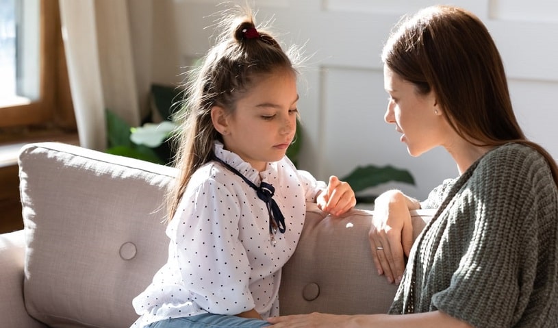 Mother talking to her child about bullying in schools.