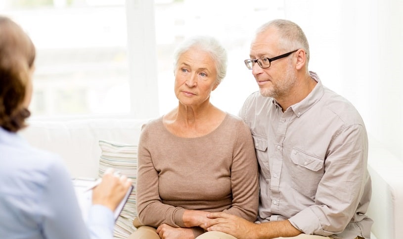 Elderly couple talking to a doctor.