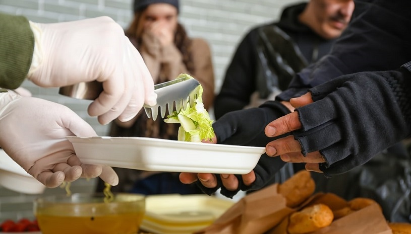 Giving food to homeless.