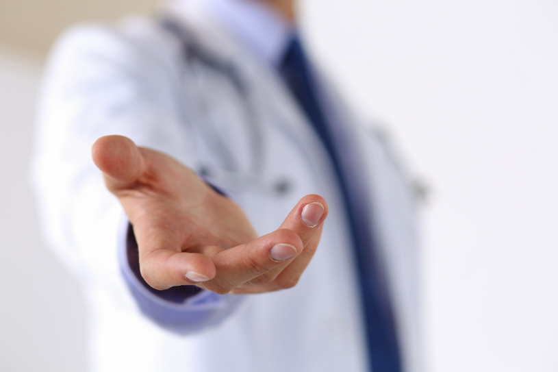A doctor stretches out his hand.