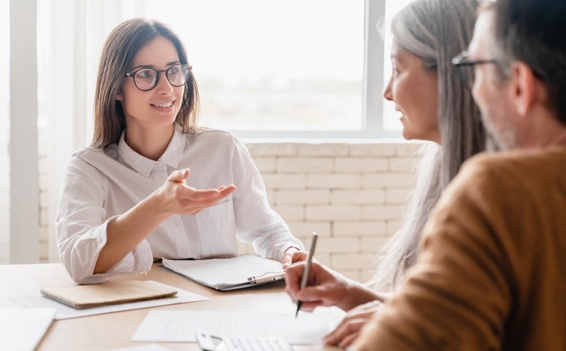 Insurance agent consulting middle-aded couple.