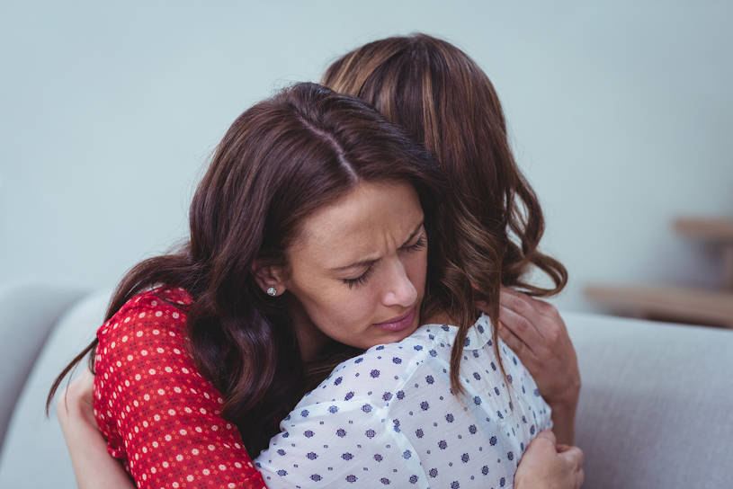 woman embracing her AA sponsor.
