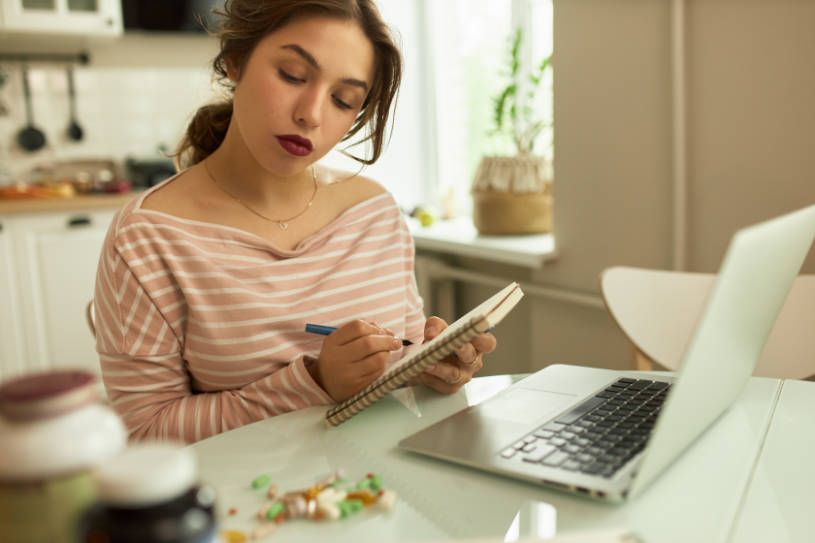 A woman googles the side effects of the pills.