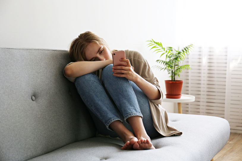A depressed woman reads information about depressant drugs.