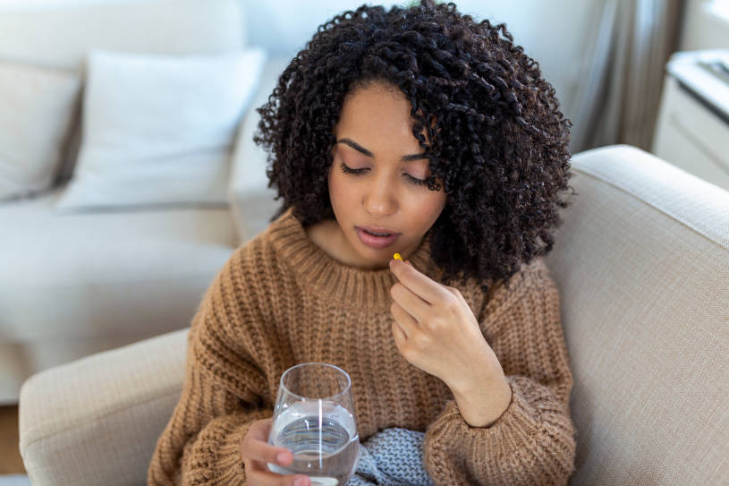 A woman holds water and drinks a sedative drug.